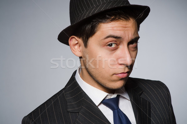 Young man in classic striped costume and hat isolated on gray Stock photo © Elnur