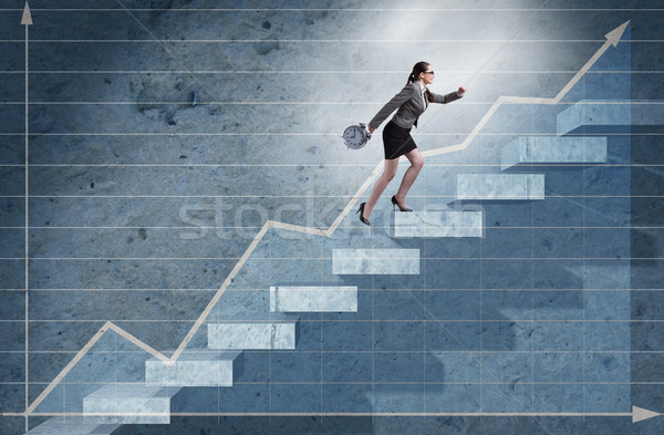 Young businesswoman climbing career ladder Stock photo © Elnur