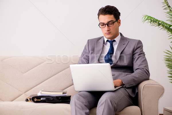 üzletember laptop notebook ül kanapé iroda Stock fotó © Elnur