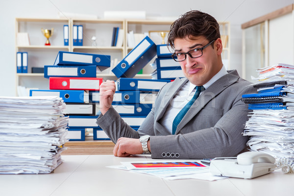 Businessman busy with much paperwork Stock photo © Elnur