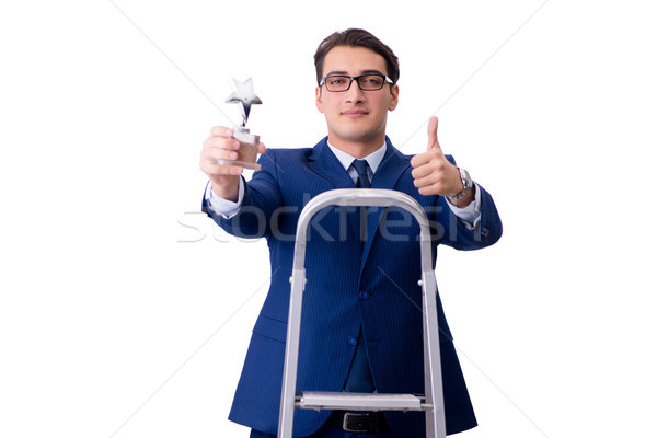 Businessman at top of ladder with star prize Stock photo © Elnur