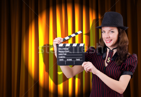 Stock photo: Woman gangster with movie clapper