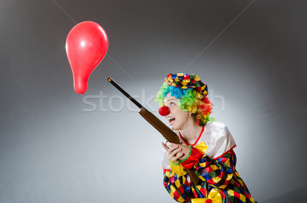 Clown with balloon and rifle in funny concept Stock photo © Elnur