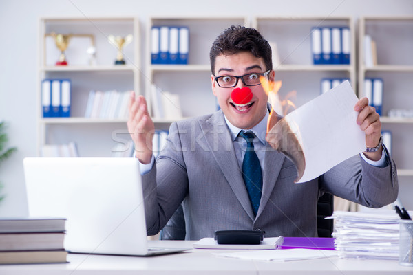 Clown businessman burning paper papers in the office Stock photo © Elnur