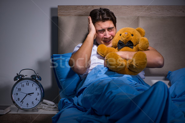 Jeune homme peur lit nuit garçon jouet [[stock_photo]] © Elnur