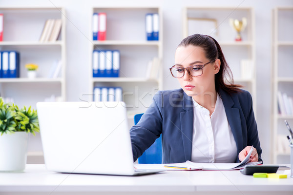 Businesswoman working in the office at desk Stock photo © Elnur