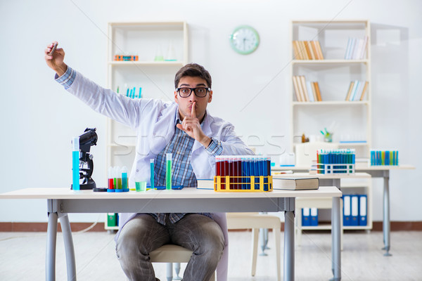 Young chemist student working in lab on chemicals Stock photo © Elnur