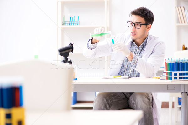 Chemistry student doing chemical experiments at classroom activi Stock photo © Elnur