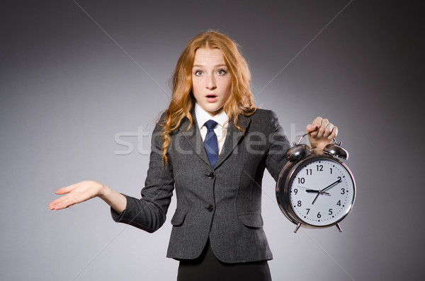 Businesswoman with clock being late for her deliverables Stock photo © Elnur