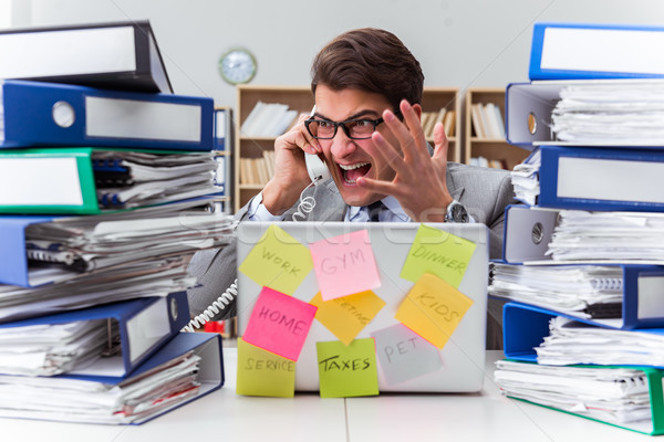 Businessman struggling with multiple priorities Stock photo © Elnur