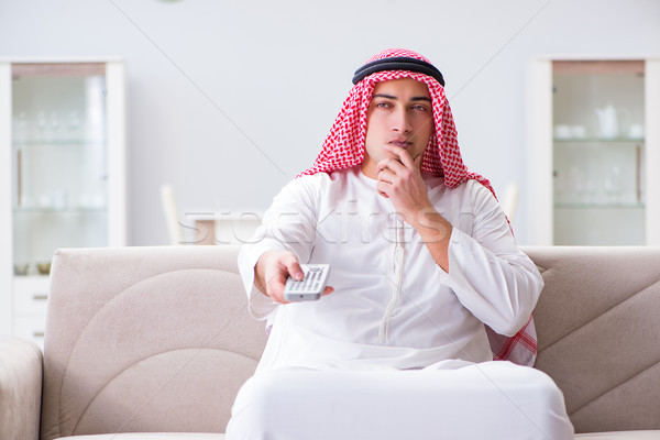 The arab man watching tv at home Stock photo © Elnur