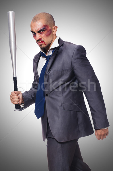Badly bruised businessman with bat on white Stock photo © Elnur