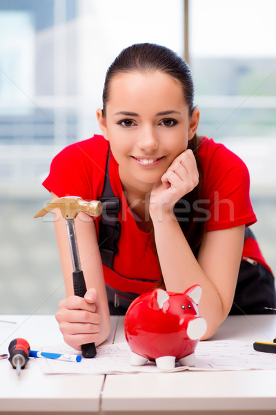 The young woman in coveralls doing repairs Stock photo © Elnur