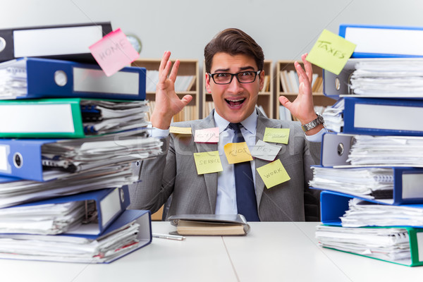 Businessman struggling with multiple priorities Stock photo © Elnur