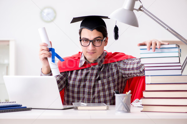 Super hero student wearing a mortarboard studying Stock photo © Elnur