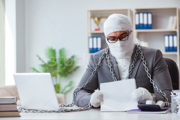Bandaged businessman worker working in the office doing paperwor Stock photo © Elnur
