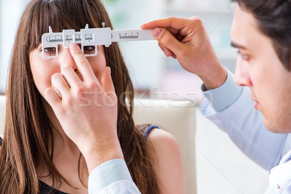 Ophthalmologist is checking up patient in eye doctor hospital Stock photo © Elnur