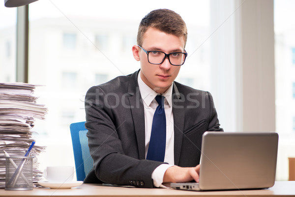 Businessman working with much paperwork Stock photo © Elnur