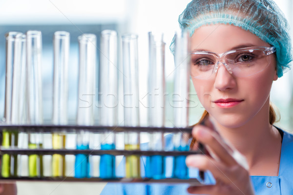 The young student working with chemical solutions in lab Stock photo © Elnur