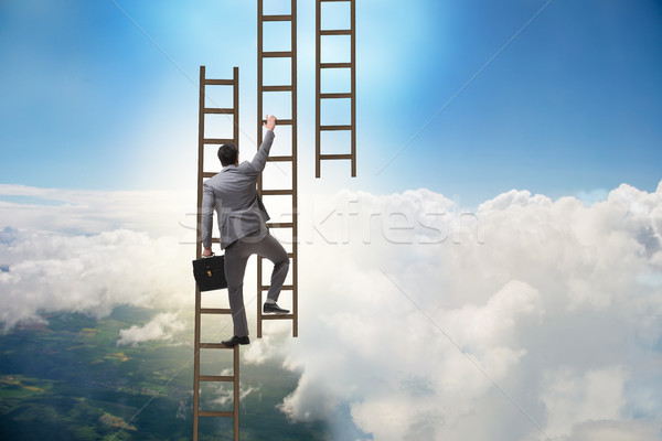 Businessman climbing career ladder in business concept Stock photo © Elnur