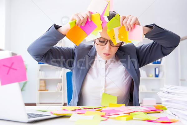 Stock photo: Businesswoman with conflicting priorities in office