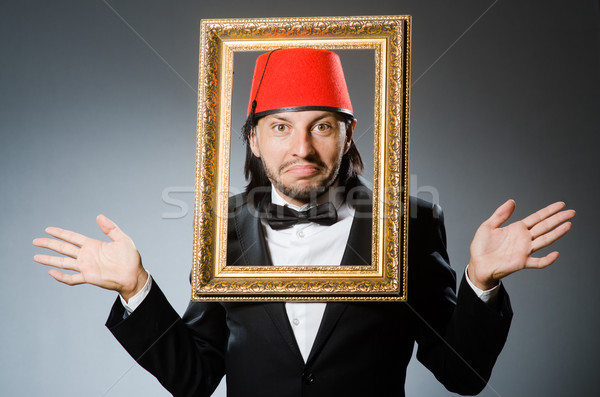 Stock photo: Man with fez  hat and picture frame