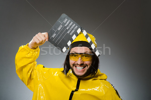 Man wearing yellow suit with movie board Stock photo © Elnur