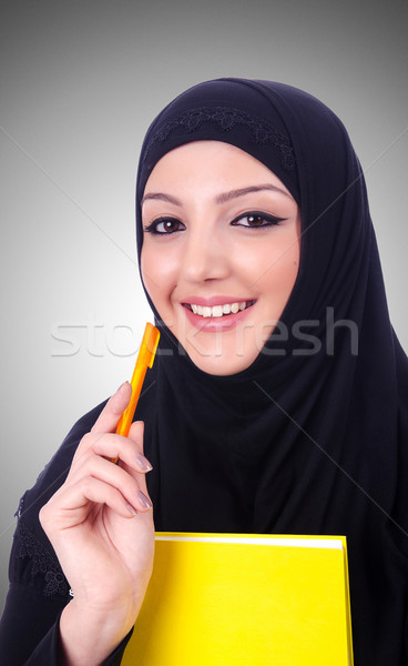 Young muslim woman with book on white Stock photo © Elnur