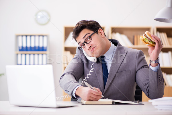 The hungry funny businessman eating junk food sandwich Stock photo © Elnur