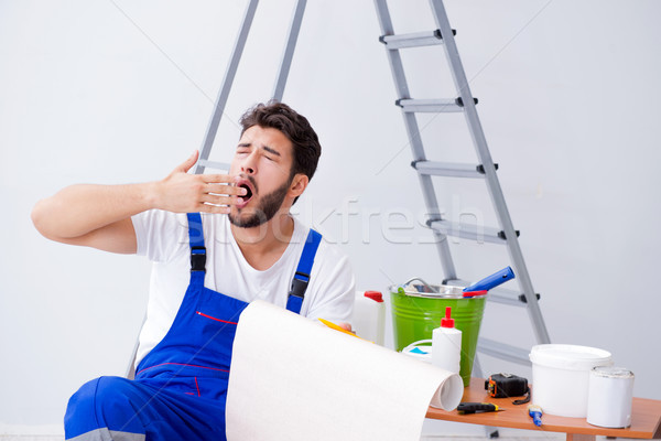 Repairman doing renovation repair in the house with paper wallpa Stock photo © Elnur