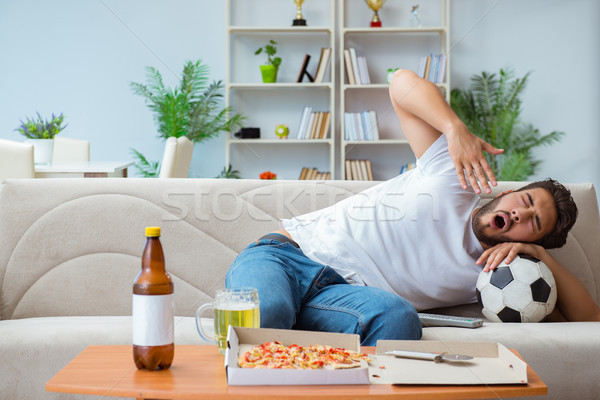 Man eating pizza having a takeaway at home relaxing resting Stock photo © Elnur