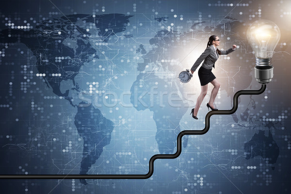 The businesswoman climbing career ladder towards light bulb Stock photo © Elnur