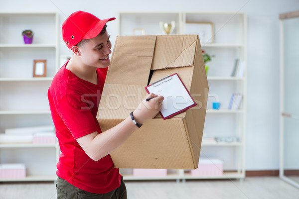 Post man delivering a parcel package Stock photo © Elnur