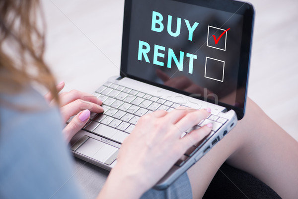 Stock photo: Businesswoman facing dilemma of buying versus renting
