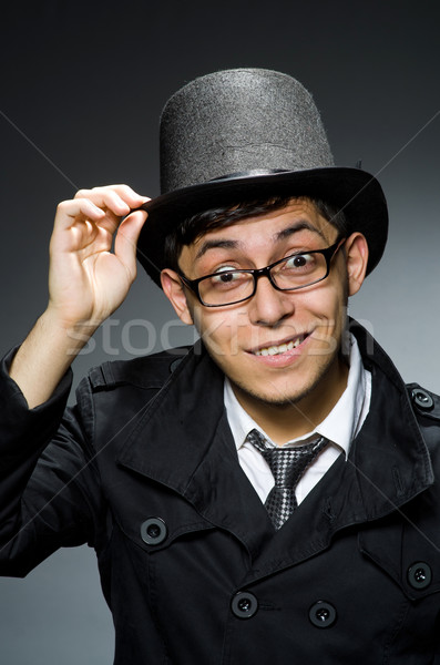 Young man in black coat and hat against gray Stock photo © Elnur