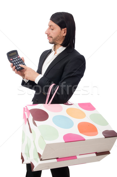 Stock photo: Man holding plastic bags and calculator isolated on white