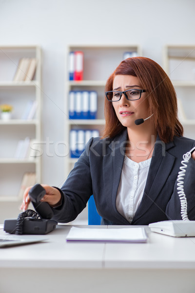 Frustrated call center assistant responding to calls Stock photo © Elnur