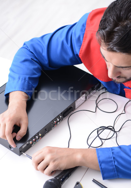 Man repairman repairing dvd player at service center Stock photo © Elnur