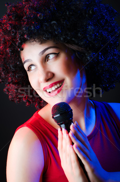 Stock photo: Female performer at disco with mic