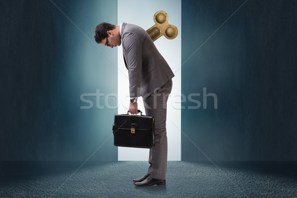 Businessman with key in hardworking concept Stock photo © Elnur