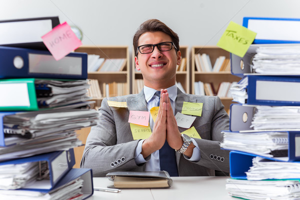 Businessman struggling with multiple priorities Stock photo © Elnur