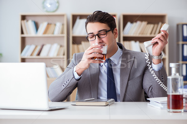 Businessman drinking in the office Stock photo © Elnur