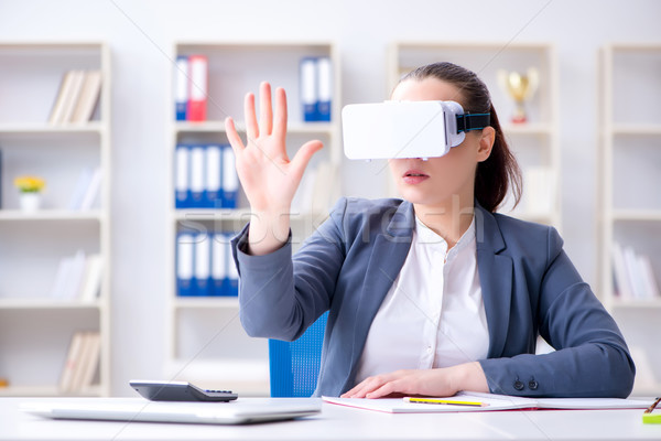 Businesswoman with virtual reality glasses in office Stock photo © Elnur