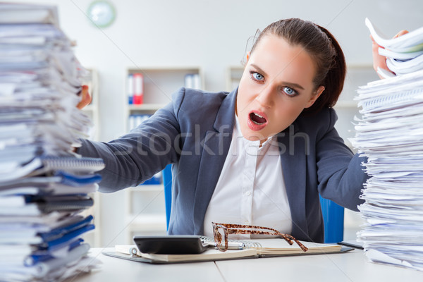 Tired businesswoman with paperwork workload Stock photo © Elnur