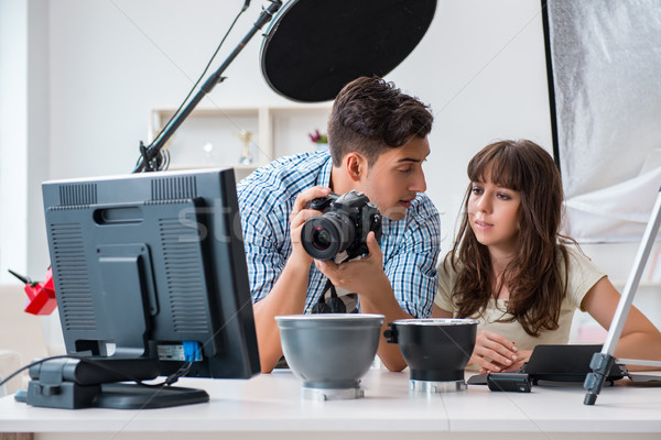 Stock photo: The young photographer working in photo studio