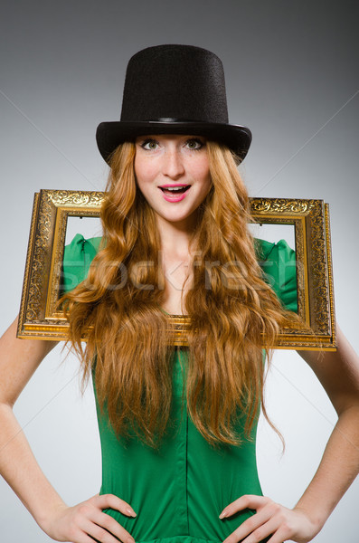 Woman wearing green dress holding picture frame Stock photo © Elnur