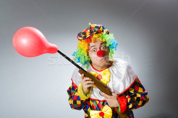 Clown with balloon and rifle in funny concept Stock photo © Elnur