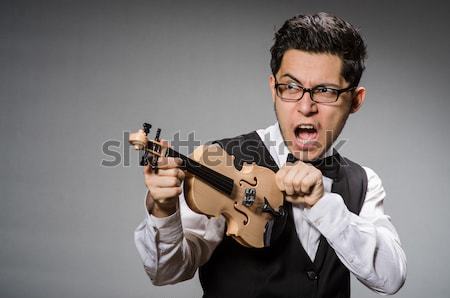 Funny prisoner with weapon isolated on gray Stock photo © Elnur