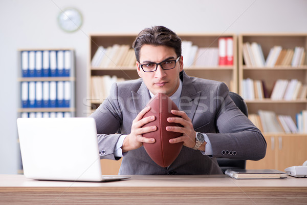 Businessman with american football in office Stock photo © Elnur