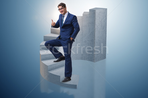 Businessman climbing career ladder in business concept Stock photo © Elnur